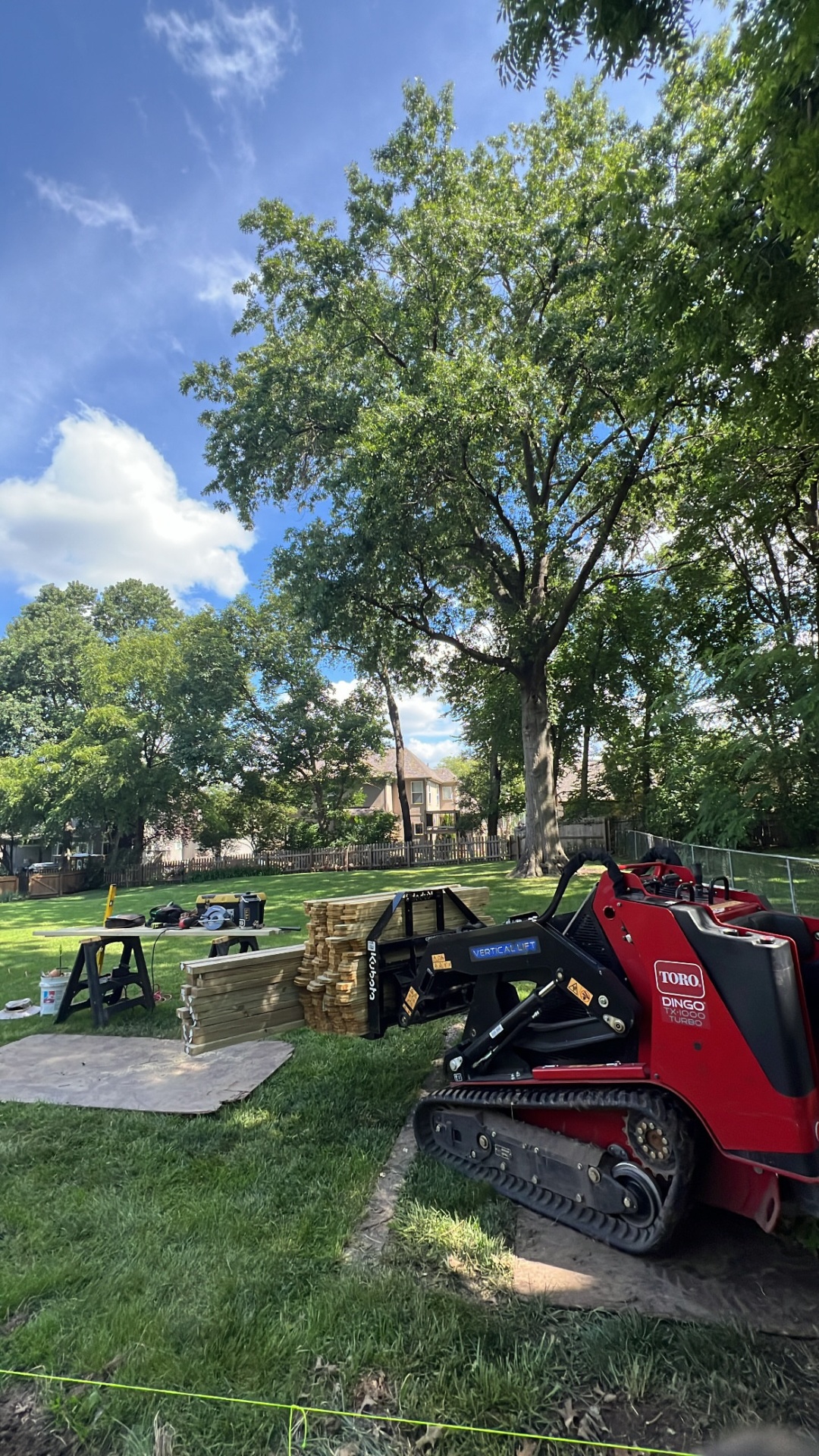 Toro Dingo track loader and lumber staged for a Kansas City landscape build by Juke KC