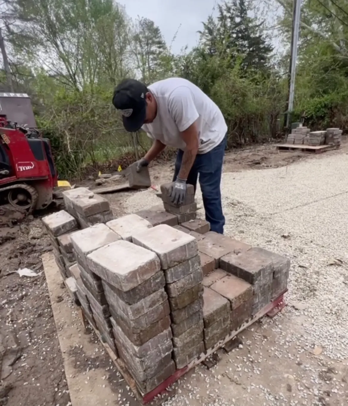 Juke KC employee installing pavers with precision craftsmanship and professional tools